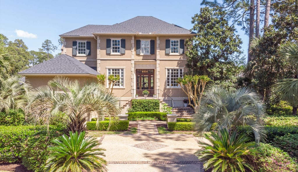 sunny mansion with palm trees